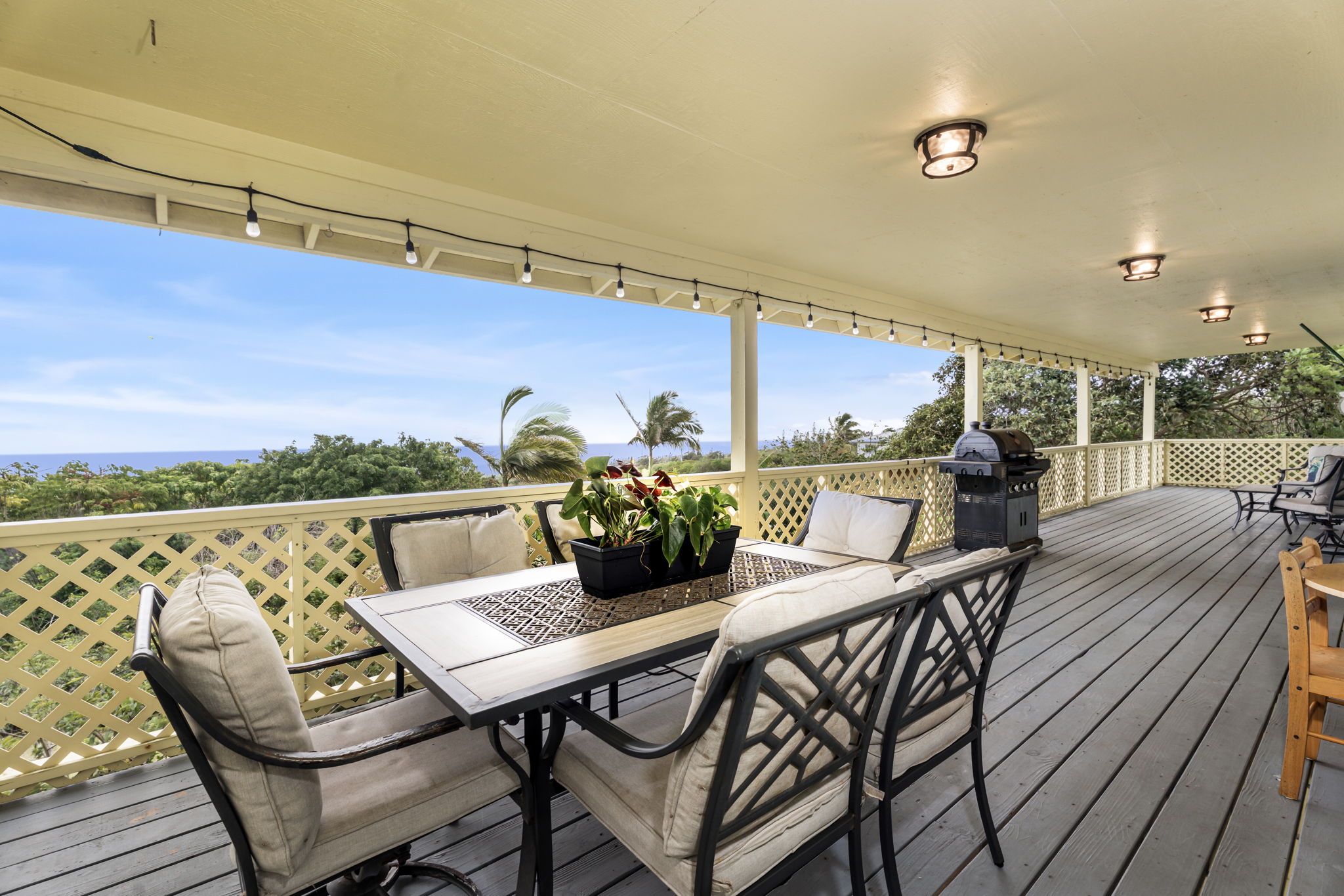 94-6494 Keoki Road Naalehu, HI 96772 - Photo 1 of 30 a view of a dining room with furniture and wooden floor