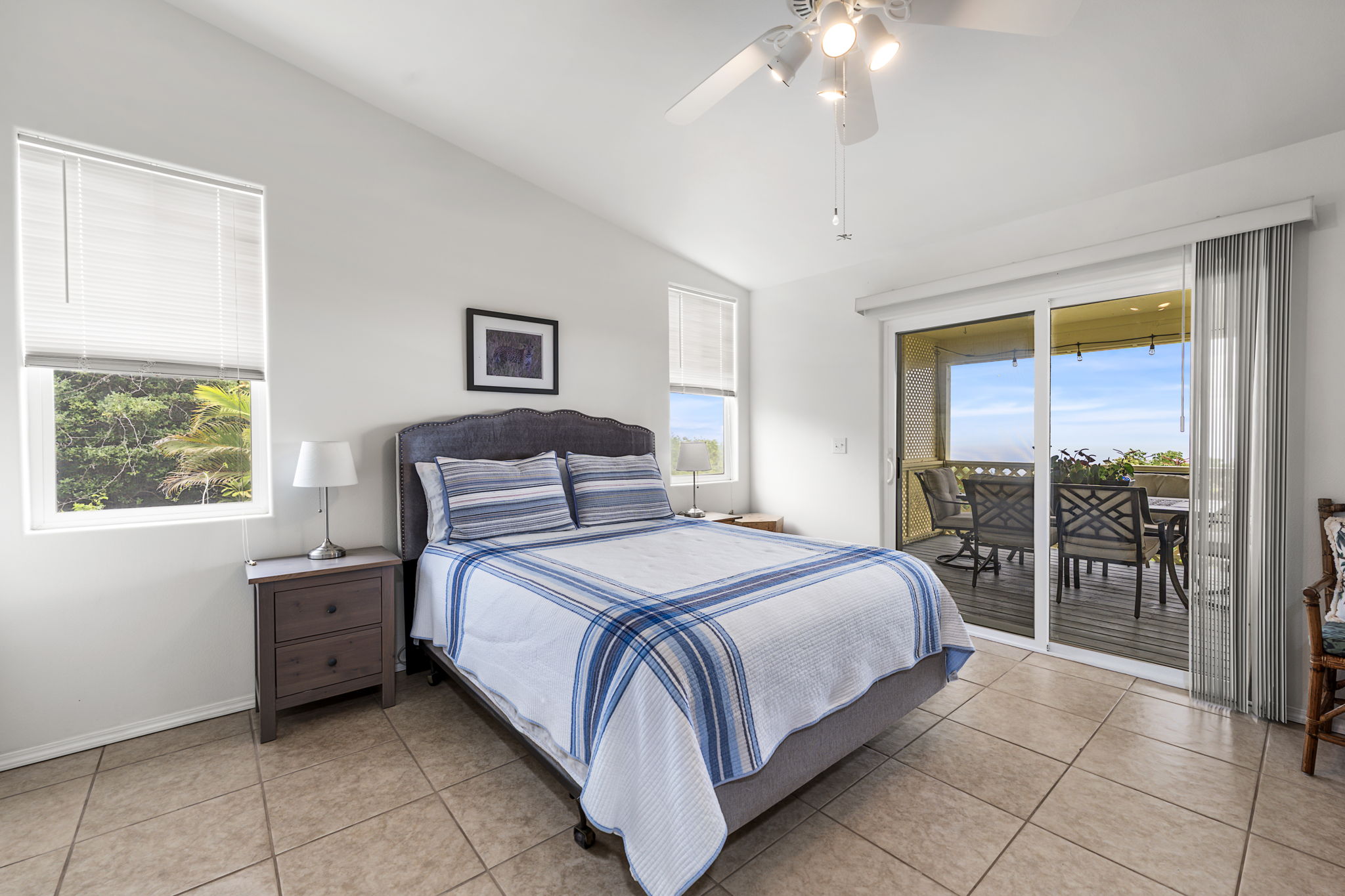 94-6494 Keoki Road Naalehu, HI 96772 - Photo 13 of 30 a bedroom with a bed and a large window