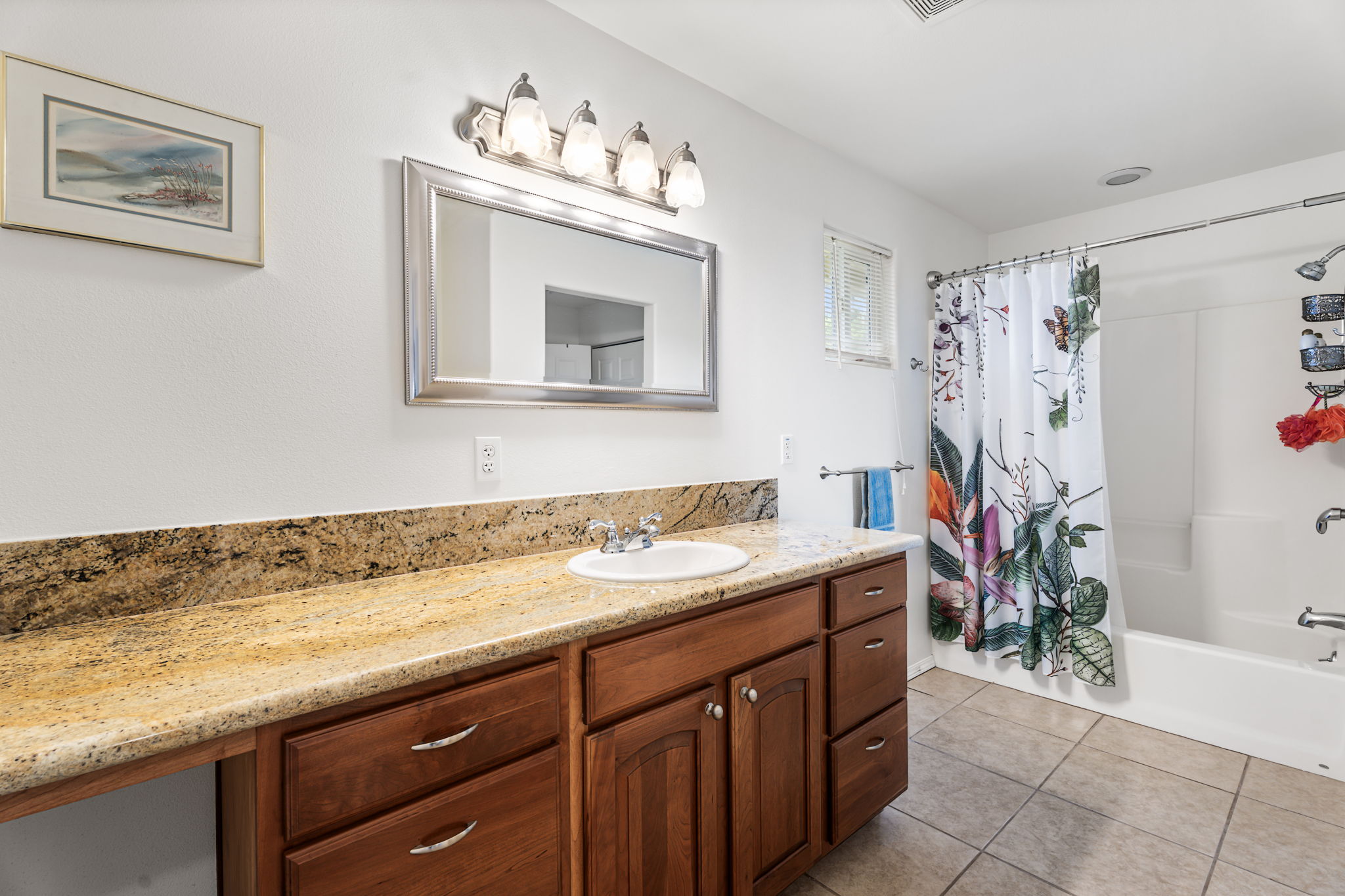 94-6494 Keoki Road Naalehu, HI 96772 - Photo 14 of 30 a bathroom with a granite countertop sink a mirror and a shower