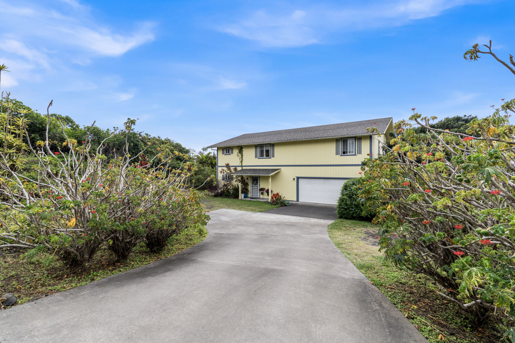 94-6494 Keoki Road Naalehu, HI 96772 - Photo 19 of 30 a front view of a house with a yard and garage