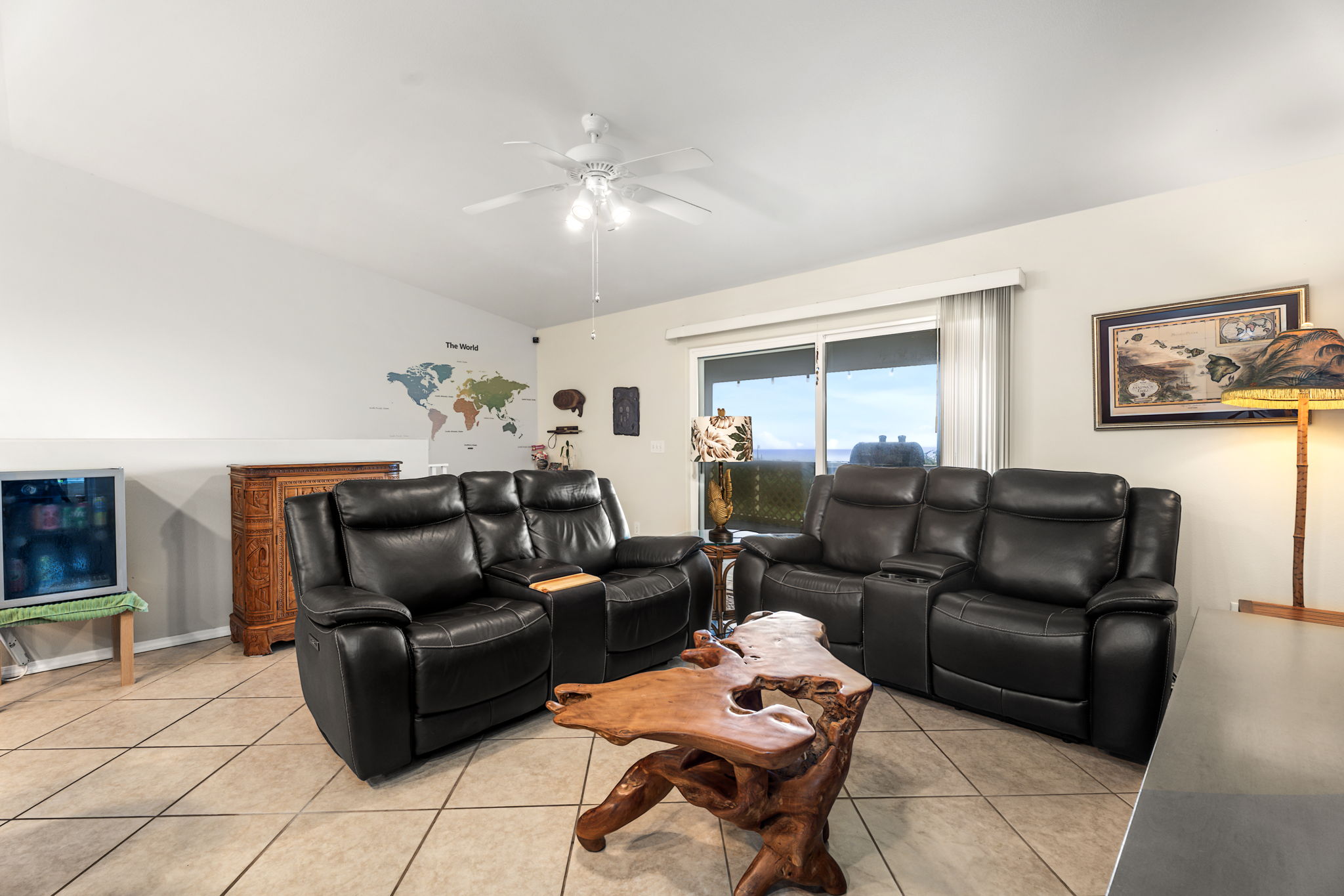 94-6494 Keoki Road Naalehu, HI 96772 - Photo 6 of 30 a living room with furniture and a chandelier