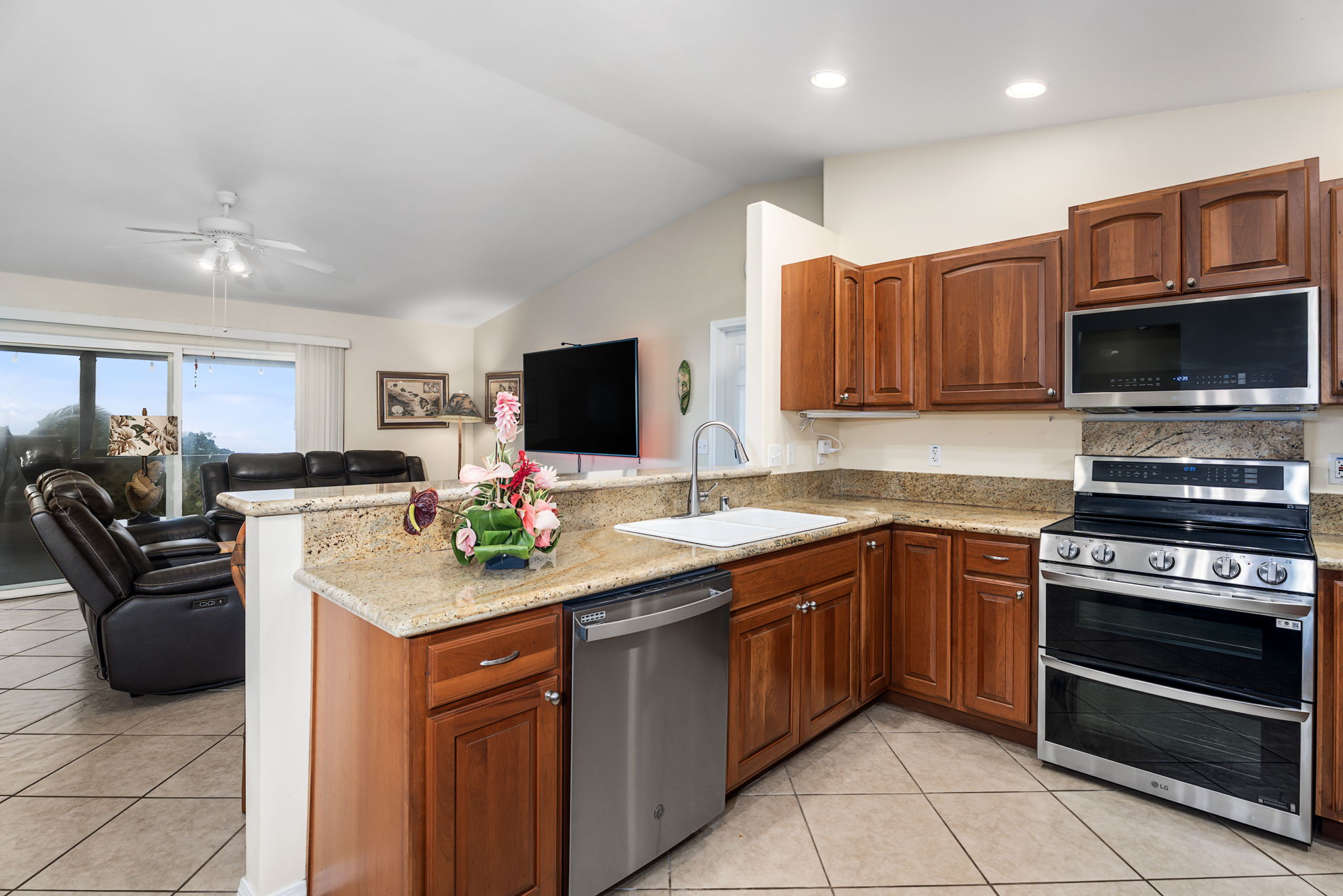 94-6494 Keoki Road Naalehu, HI 96772 - Photo 9 of 30 a kitchen with a sink stove and microwave