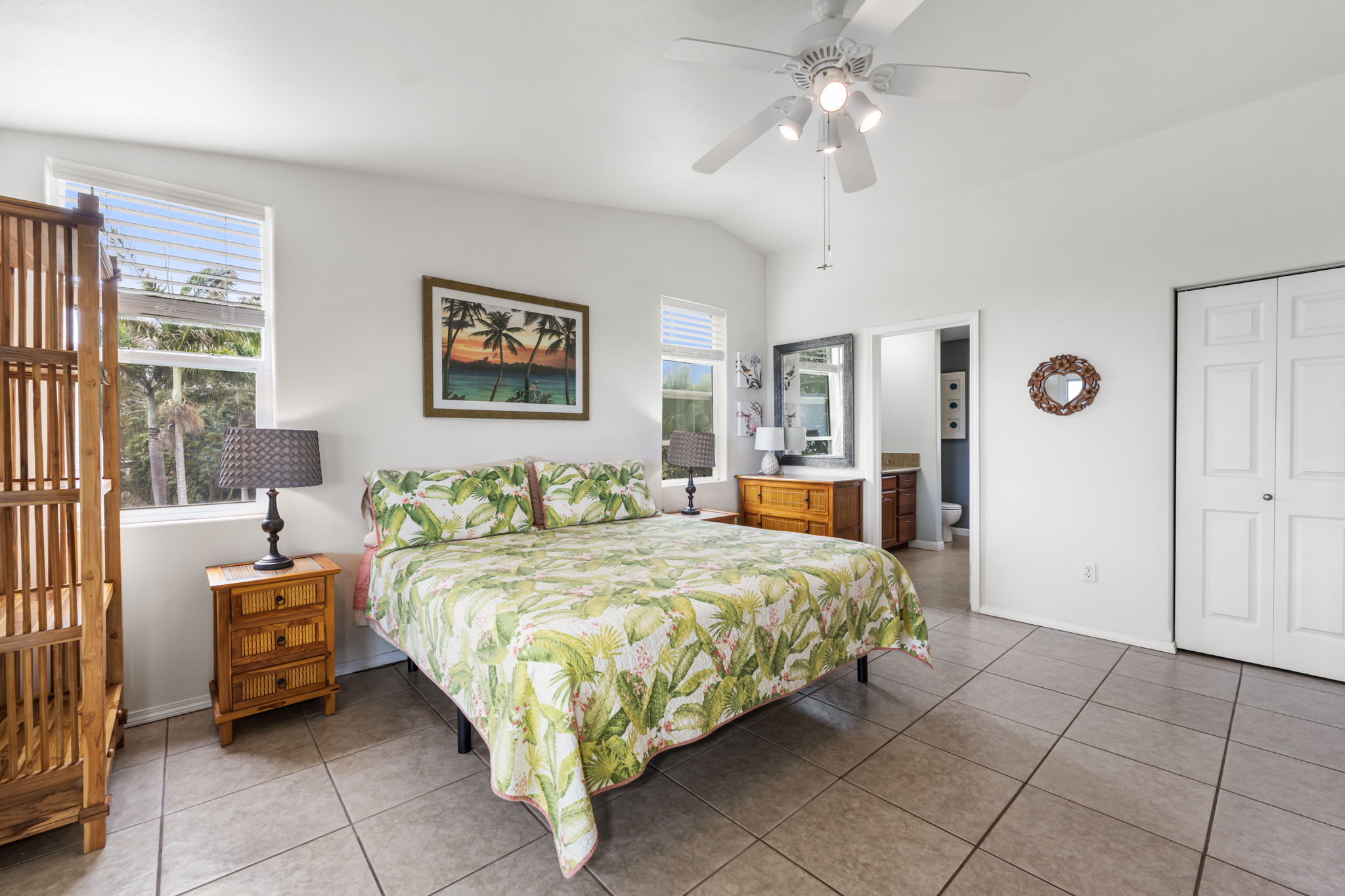 94-6494 Keoki Road Naalehu, HI 96772 - Photo 10 of 30 a bedroom with a bed and a chandelier