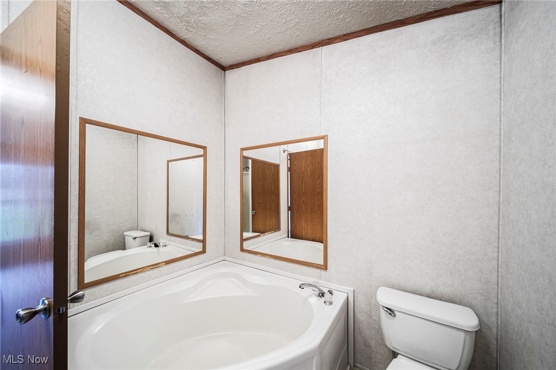 6835 Sidley Road Thompson, OH 44086 - Photo 18 of 39 Bathroom with a textured ceiling and ornamental molding