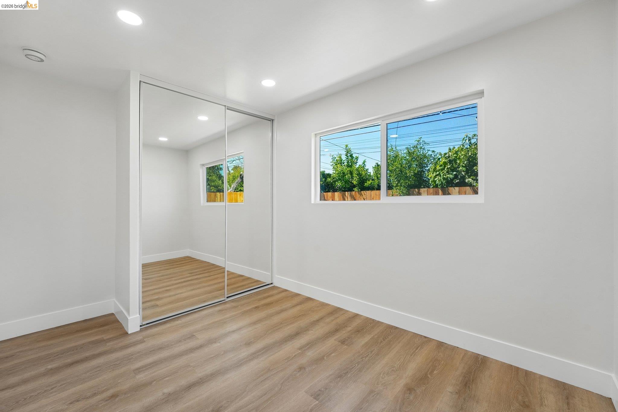 375 Senter Road San Jose, CA 95111 - Photo 45 of 80 an empty room with wooden floor and windows