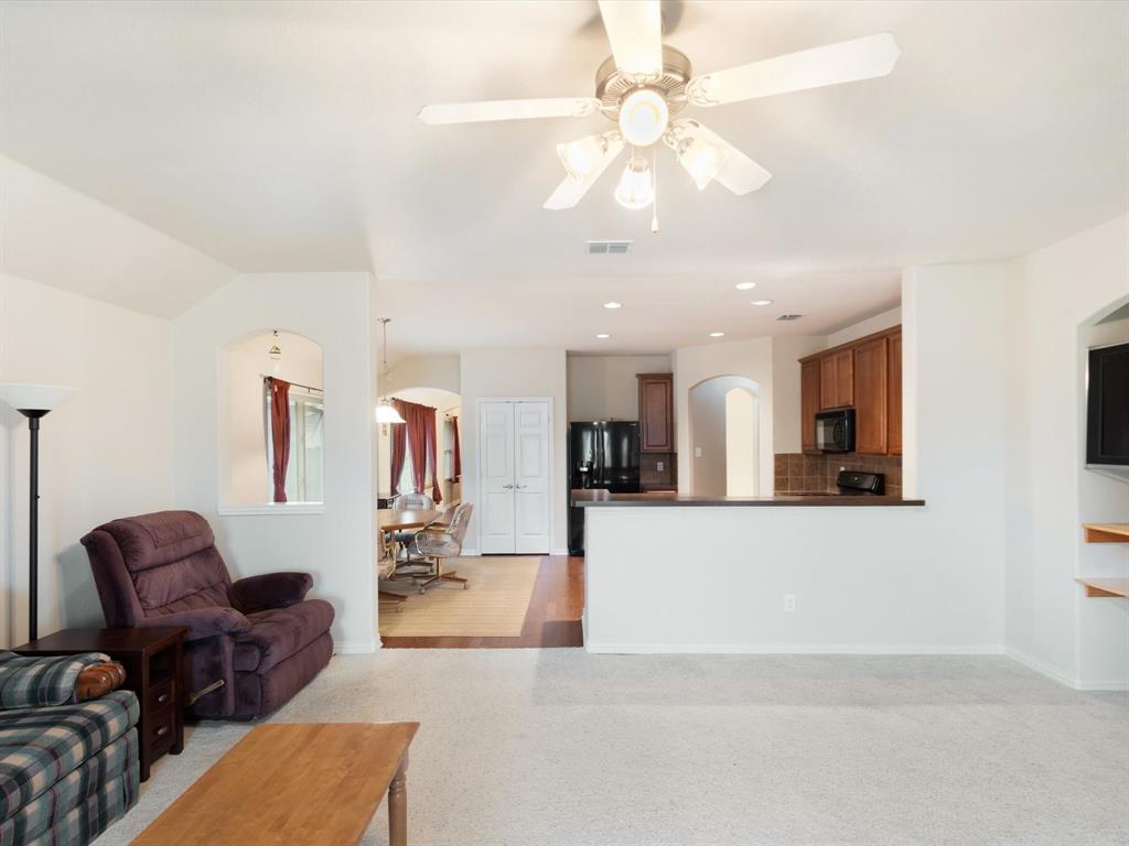 5440 Lavaca Road Grand Prairie, TX 75052 - Photo 17 of 22 Recessed lighting, arched entryways, wood-finish flooring, built-in shelving, and a ceiling fan with light fixture