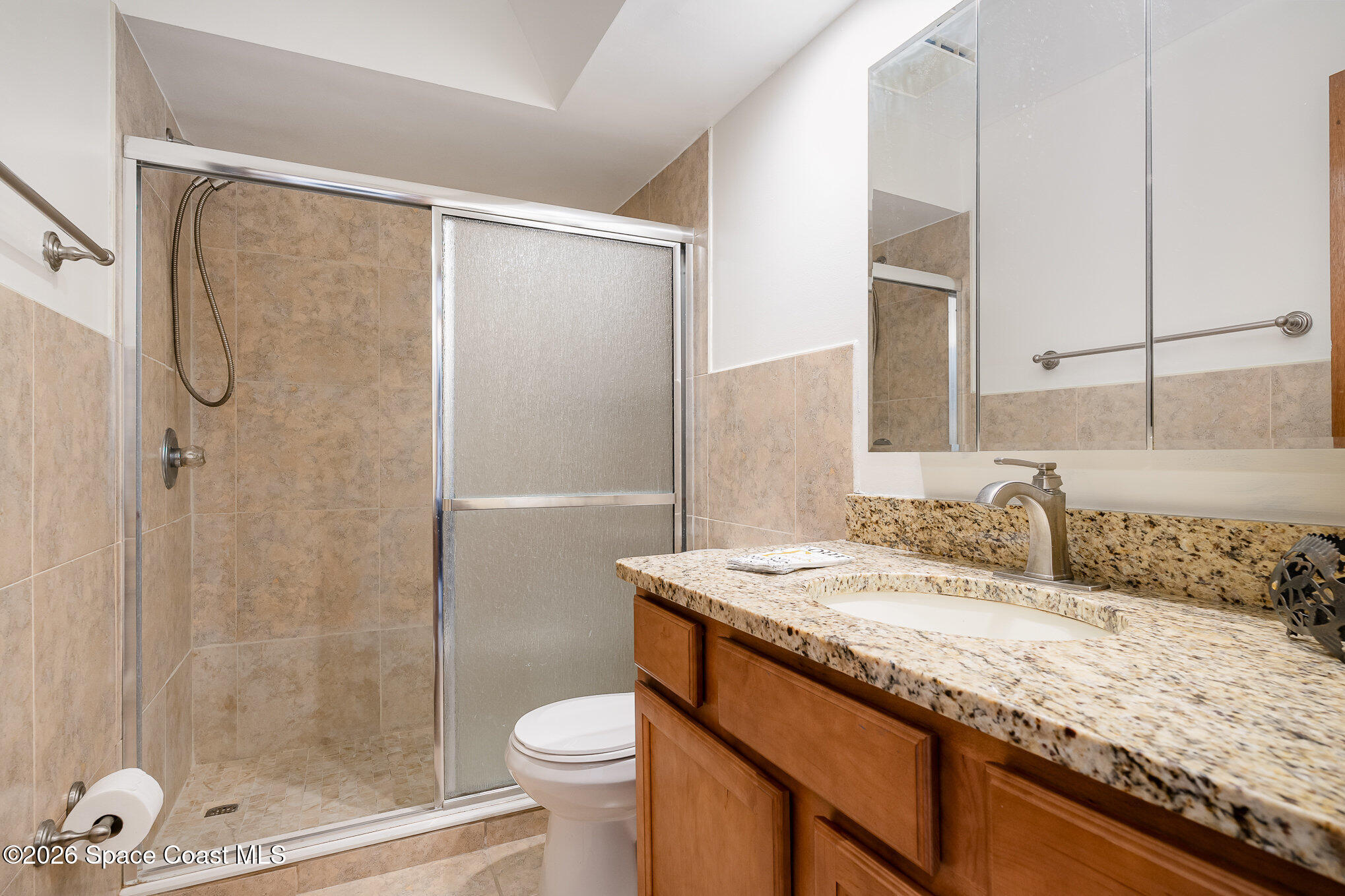 3021 Kirkland Road Northeast Palm Bay, FL 32905 - Photo 15 of 16 a bathroom with a granite countertop sink toilet and shower