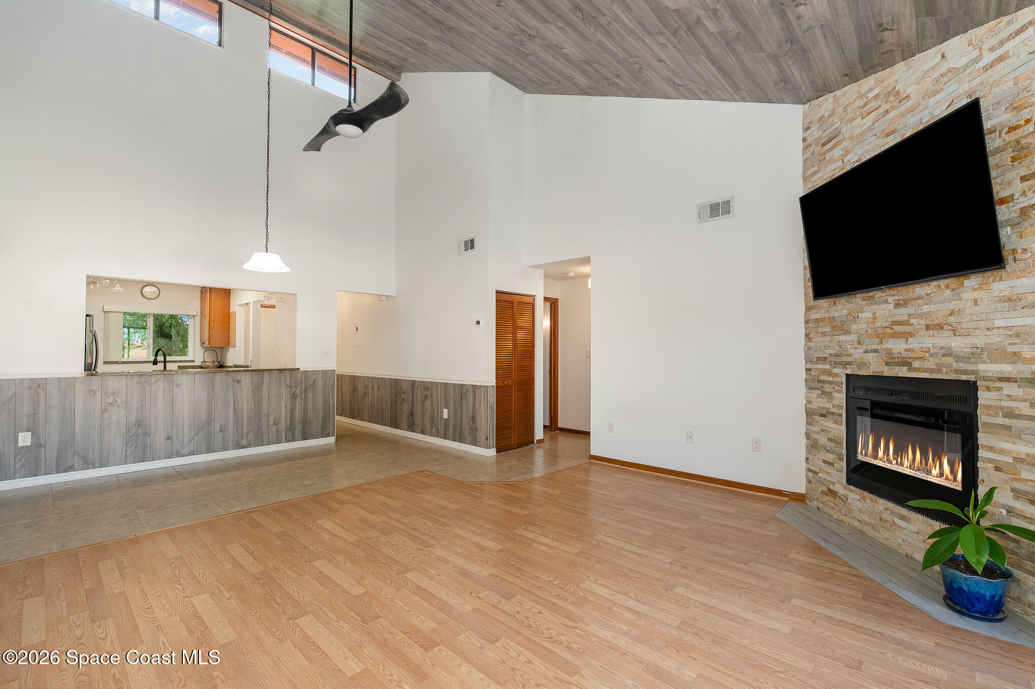 3021 Kirkland Road Northeast Palm Bay, FL 32905 - Photo 7 of 16 a view of an empty room with wooden floor and a fireplace