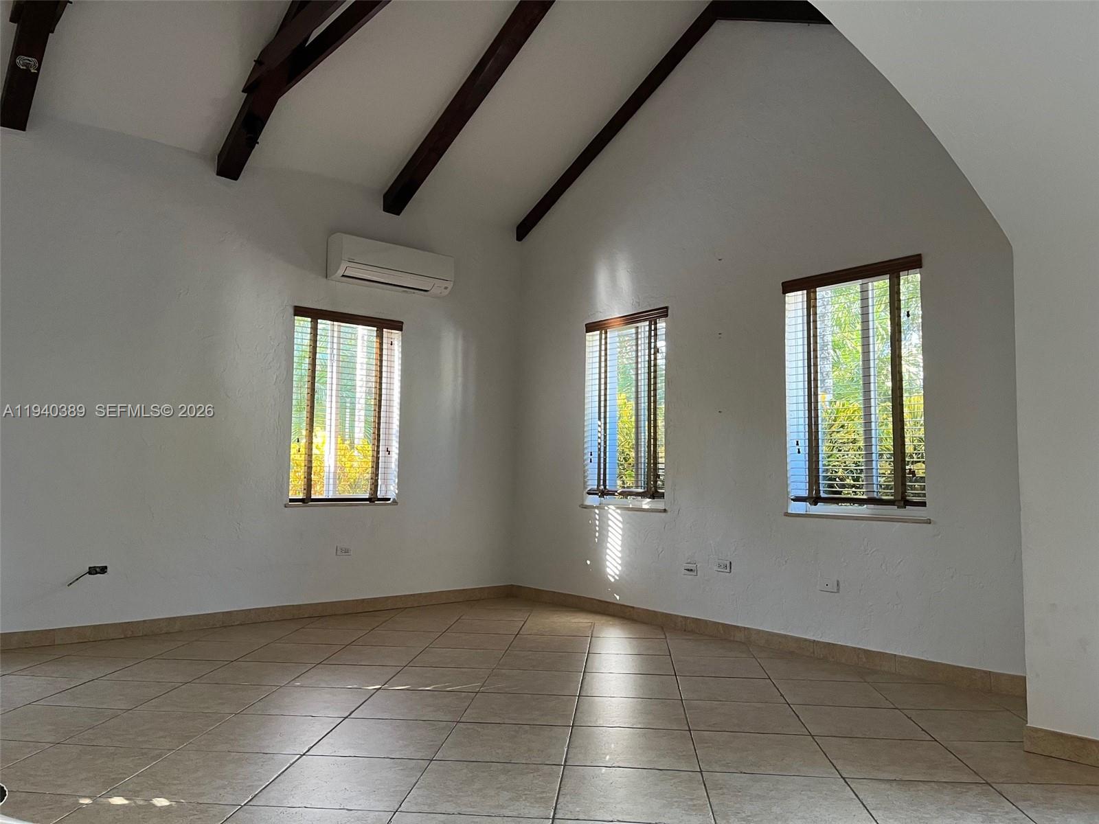 7975 Sunset Drive Miami, FL 33143 - Photo 4 of 8 an empty room with windows