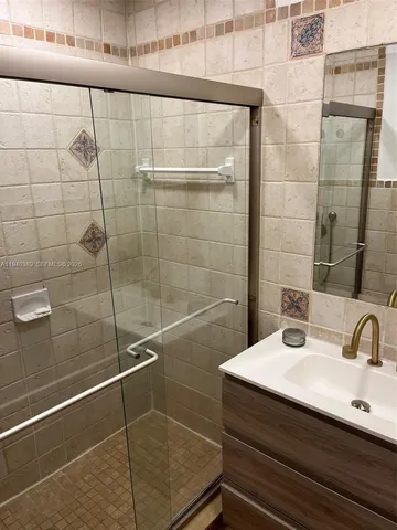 a bathroom with a sink and mirror