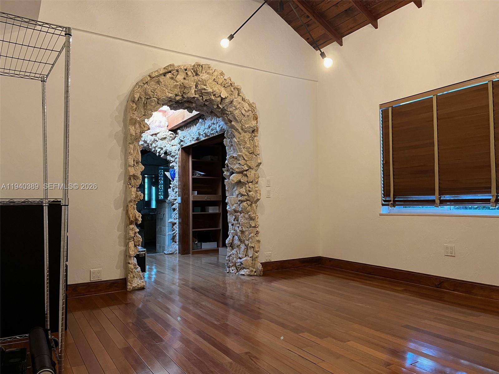 7975 Sunset Drive Miami, FL 33143 - Photo 7 of 8 wooden floor in an empty room with a window