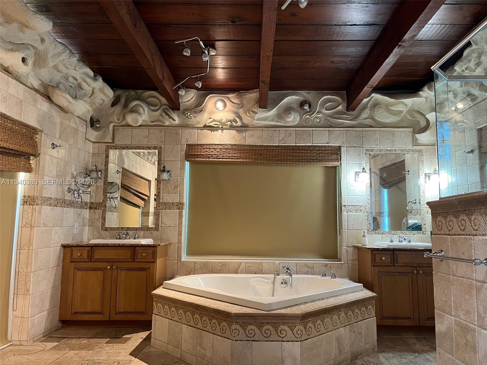 7975 Sunset Drive Miami, FL 33143 - Photo 8 of 8 a bathroom with a sink and a mirror