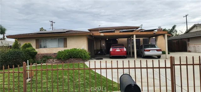 a view of a house with a small yard and a potted plant