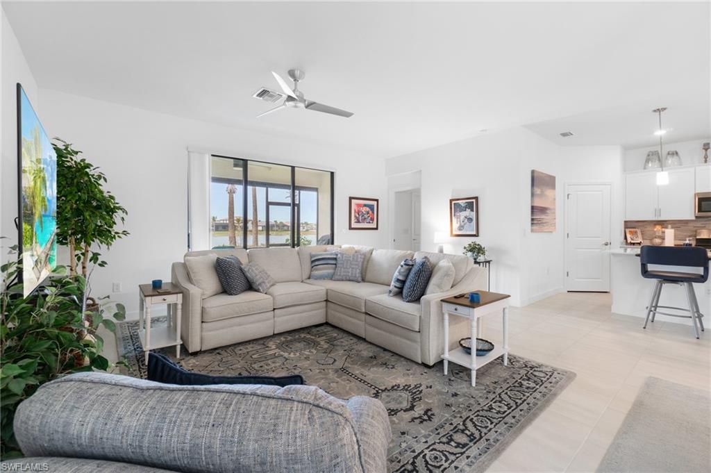 20238 Millrun Drive Estero, FL 33928 - Photo 12 of 41 a living room with furniture and a potted plant