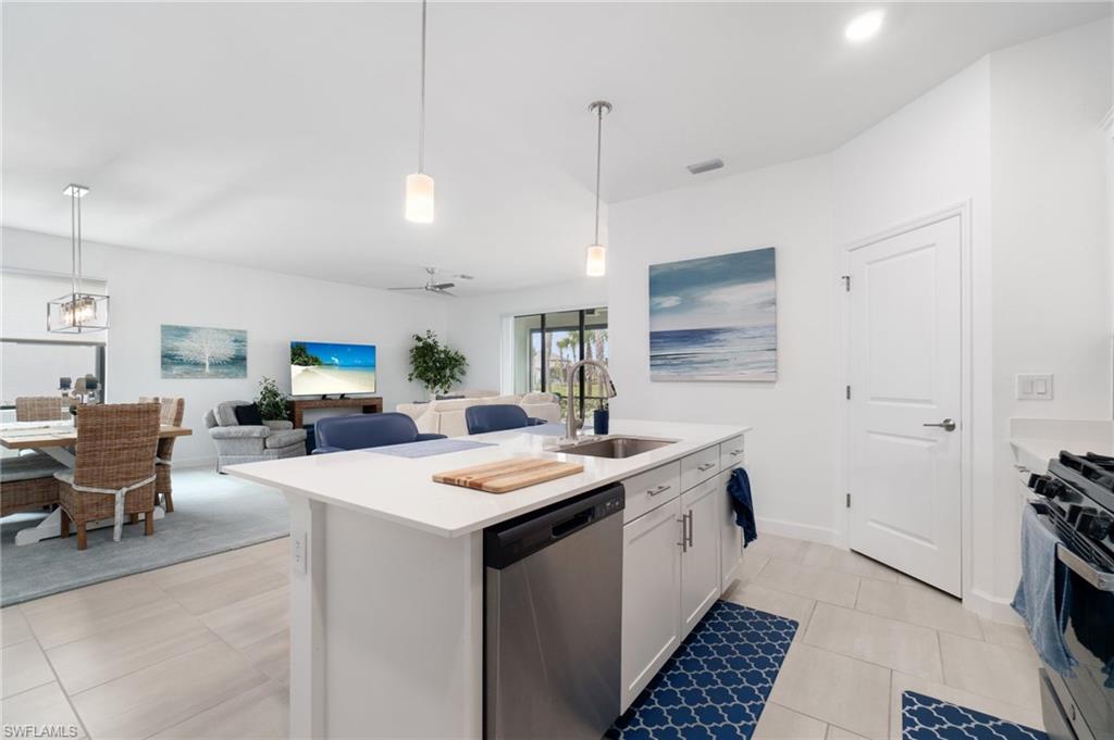20238 Millrun Drive Estero, FL 33928 - Photo 13 of 41 a kitchen that has a lot of cabinets in it