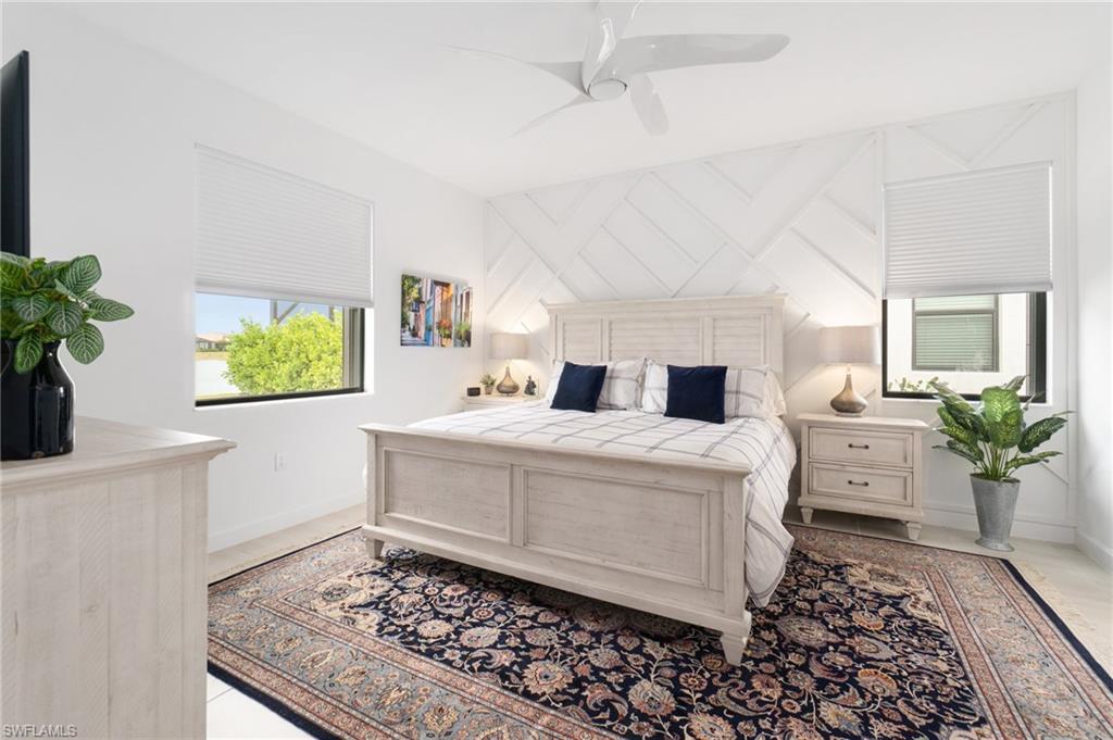 20238 Millrun Drive Estero, FL 33928 - Photo 17 of 41 a living room with a couch and a potted plant