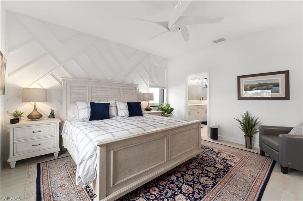 20238 Millrun Drive Estero, FL 33928 - Photo 18 of 41 a bedroom with a bed and a dresser