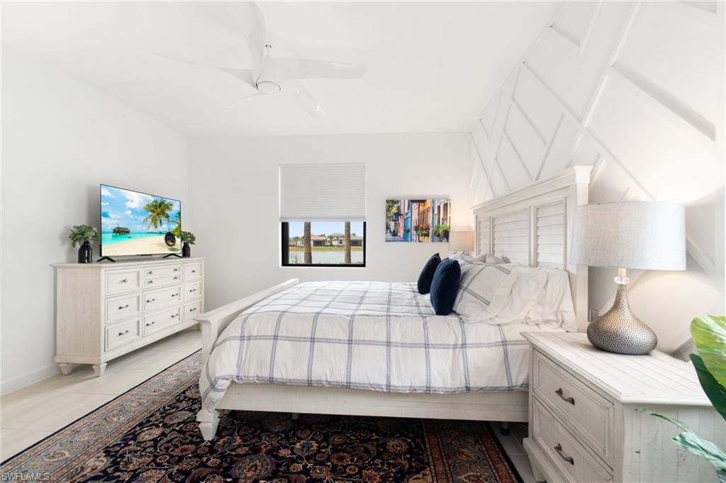 20238 Millrun Drive Estero, FL 33928 - Photo 19 of 41 a bedroom with a large bed and a flat tv screen on dresser
