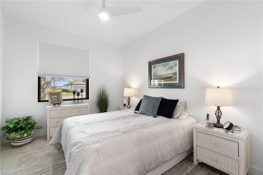 20238 Millrun Drive Estero, FL 33928 - Photo 22 of 41 a bedroom with a bed and a potted plant