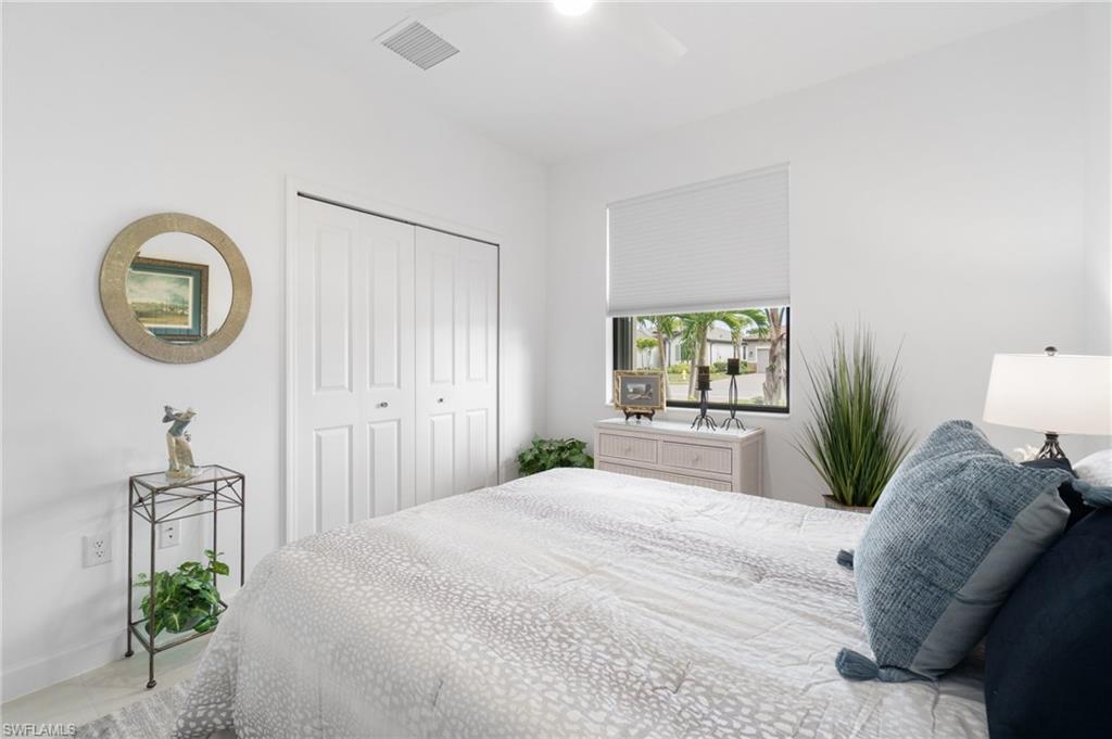 20238 Millrun Drive Estero, FL 33928 - Photo 23 of 41 a bedroom with a bed and a window