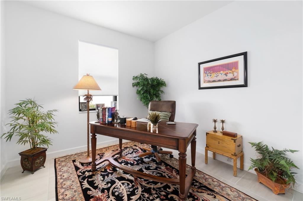 20238 Millrun Drive Estero, FL 33928 - Photo 26 of 41 a work room with furniture and a potted plant