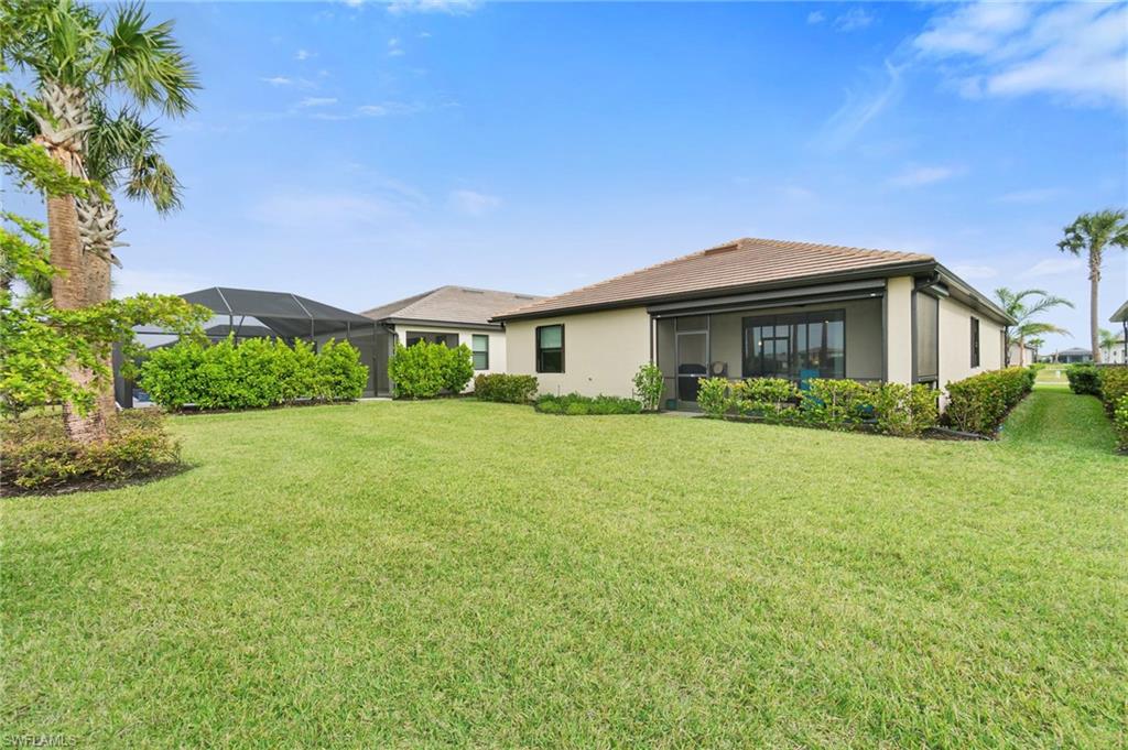 20238 Millrun Drive Estero, FL 33928 - Photo 31 of 41 a front view of a house with a yard