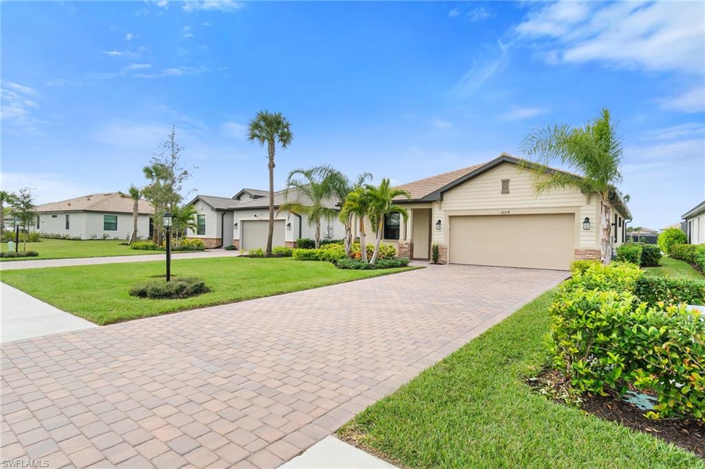 20238 Millrun Drive Estero, FL 33928 - Photo 4 of 41 a front view of a house with a yard and garage