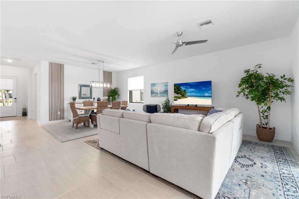 20238 Millrun Drive Estero, FL 33928 - Photo 8 of 41 a living room with furniture and a potted plant