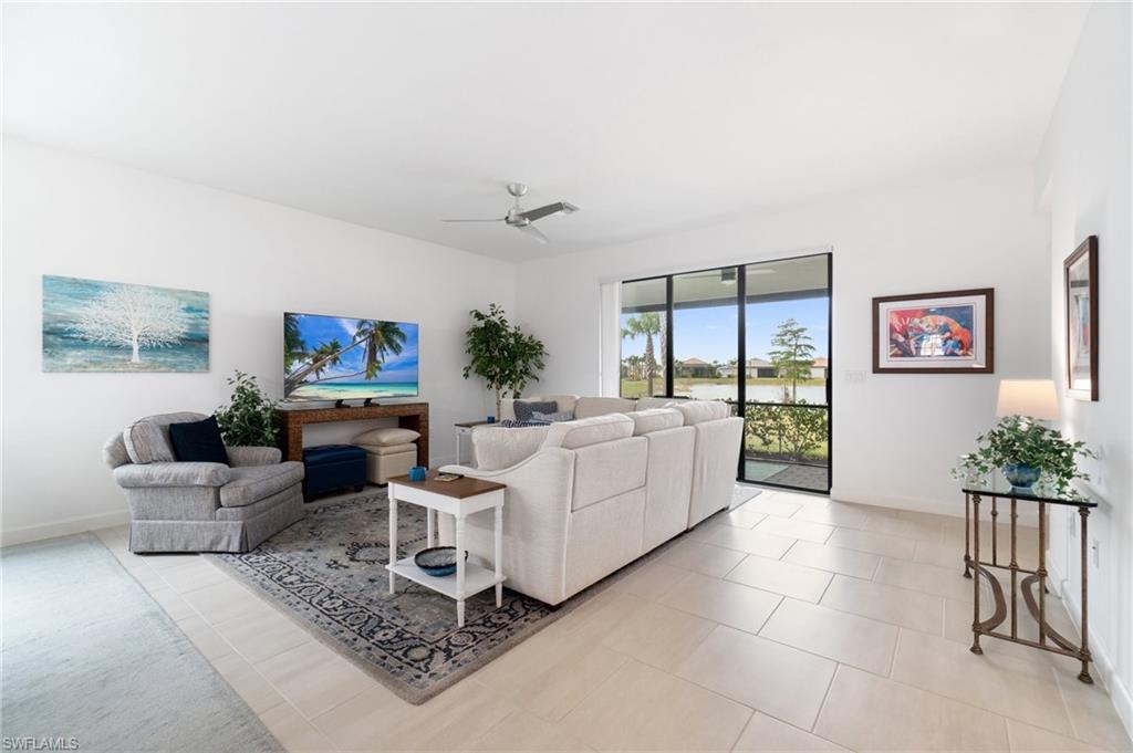 20238 Millrun Drive Estero, FL 33928 - Photo 10 of 41 a living room with furniture and a flat screen tv
