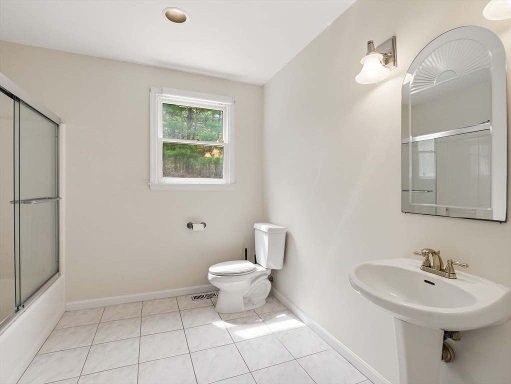 10 Hawk Ridge Road Andover, MA 01810 - Photo 16 of 32 a bathroom with a sink a toilet and a mirror
