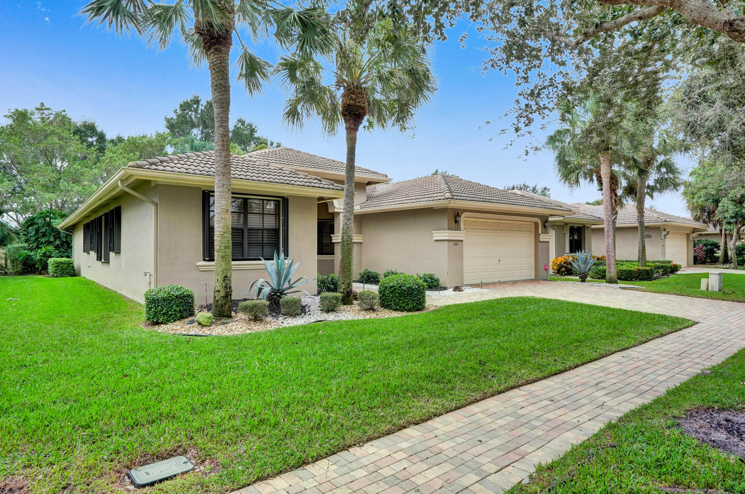 7849 Via Grande Boynton Beach, FL 33437 - Photo 3 of 59 a front view of a house with garden and porch