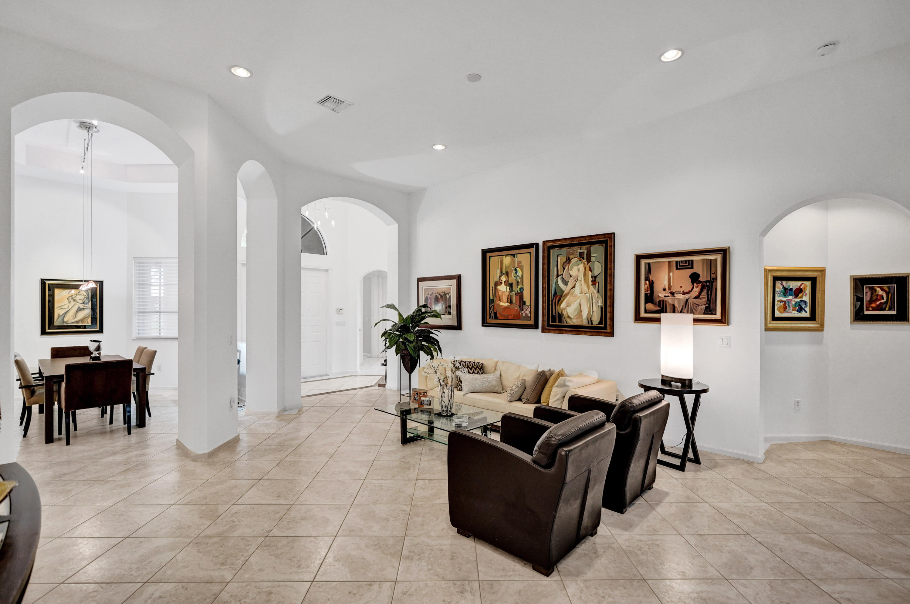 7849 Via Grande Boynton Beach, FL 33437 - Photo 22 of 59 a living room with furniture and a dining table with potted plants
