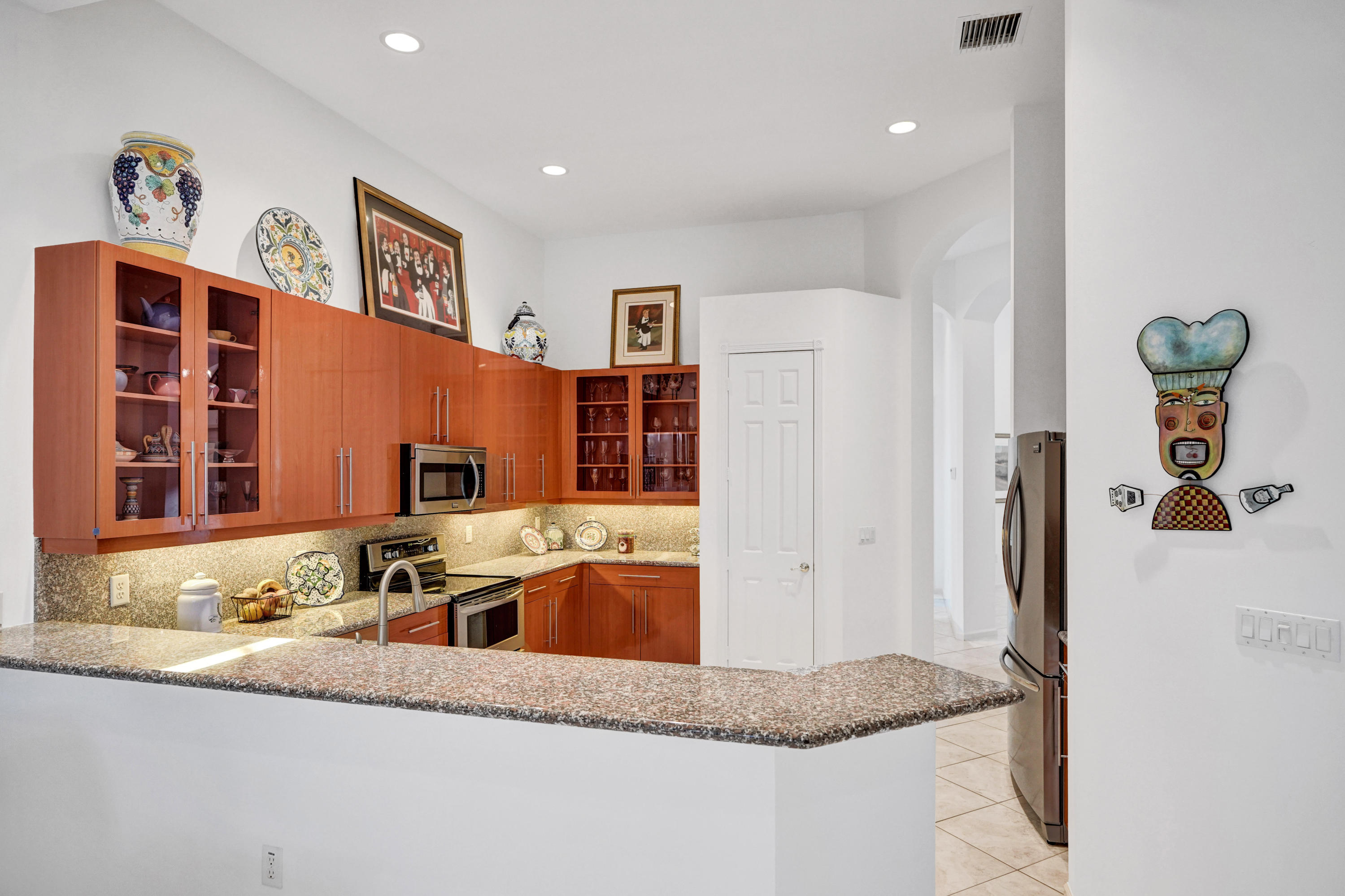 7849 Via Grande Boynton Beach, FL 33437 - Photo 26 of 59 a kitchen with stainless steel appliances granite countertop a refrigerator and a sink