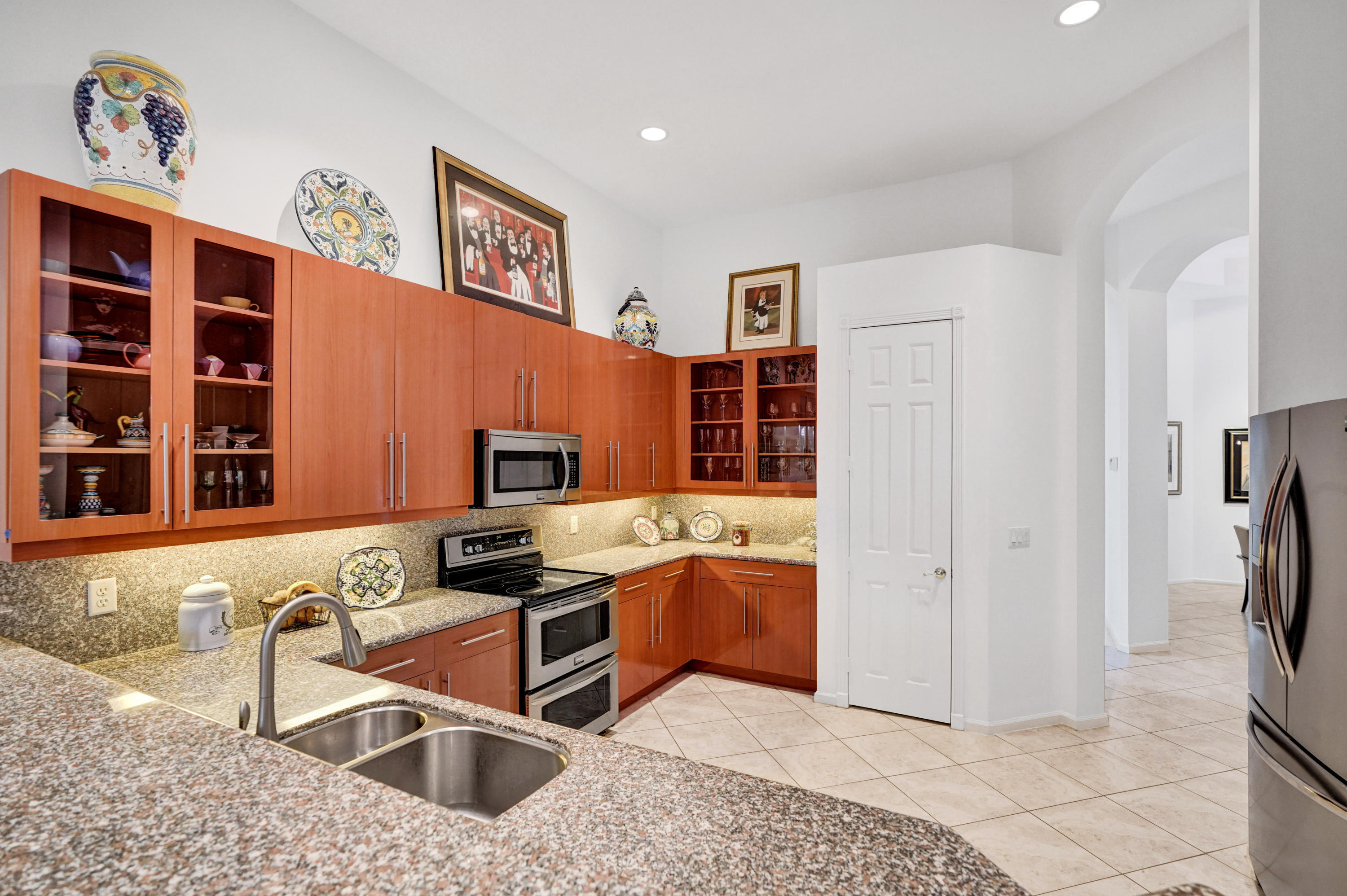 7849 Via Grande Boynton Beach, FL 33437 - Photo 27 of 59 a kitchen with stainless steel appliances granite countertop a refrigerator and a sink