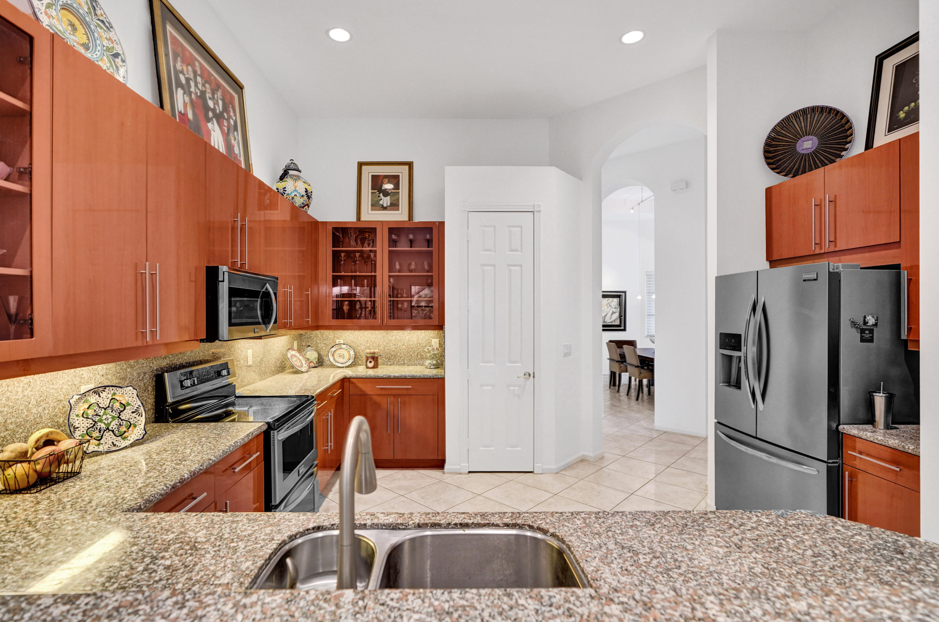 7849 Via Grande Boynton Beach, FL 33437 - Photo 30 of 59 a kitchen with stainless steel appliances granite countertop a sink refrigerator stove and microwave