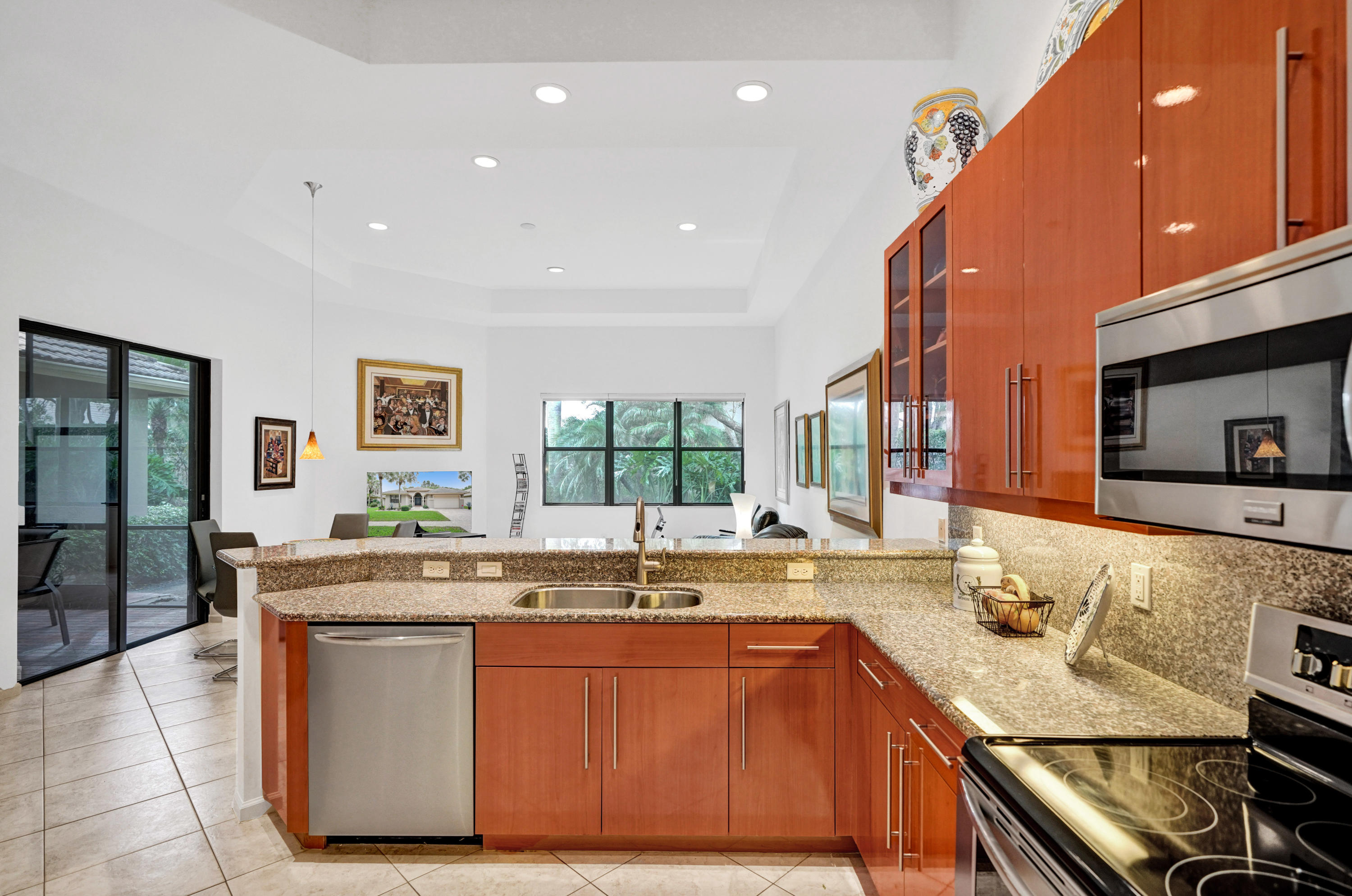 7849 Via Grande Boynton Beach, FL 33437 - Photo 31 of 59 a kitchen with stainless steel appliances granite countertop a sink and a stove