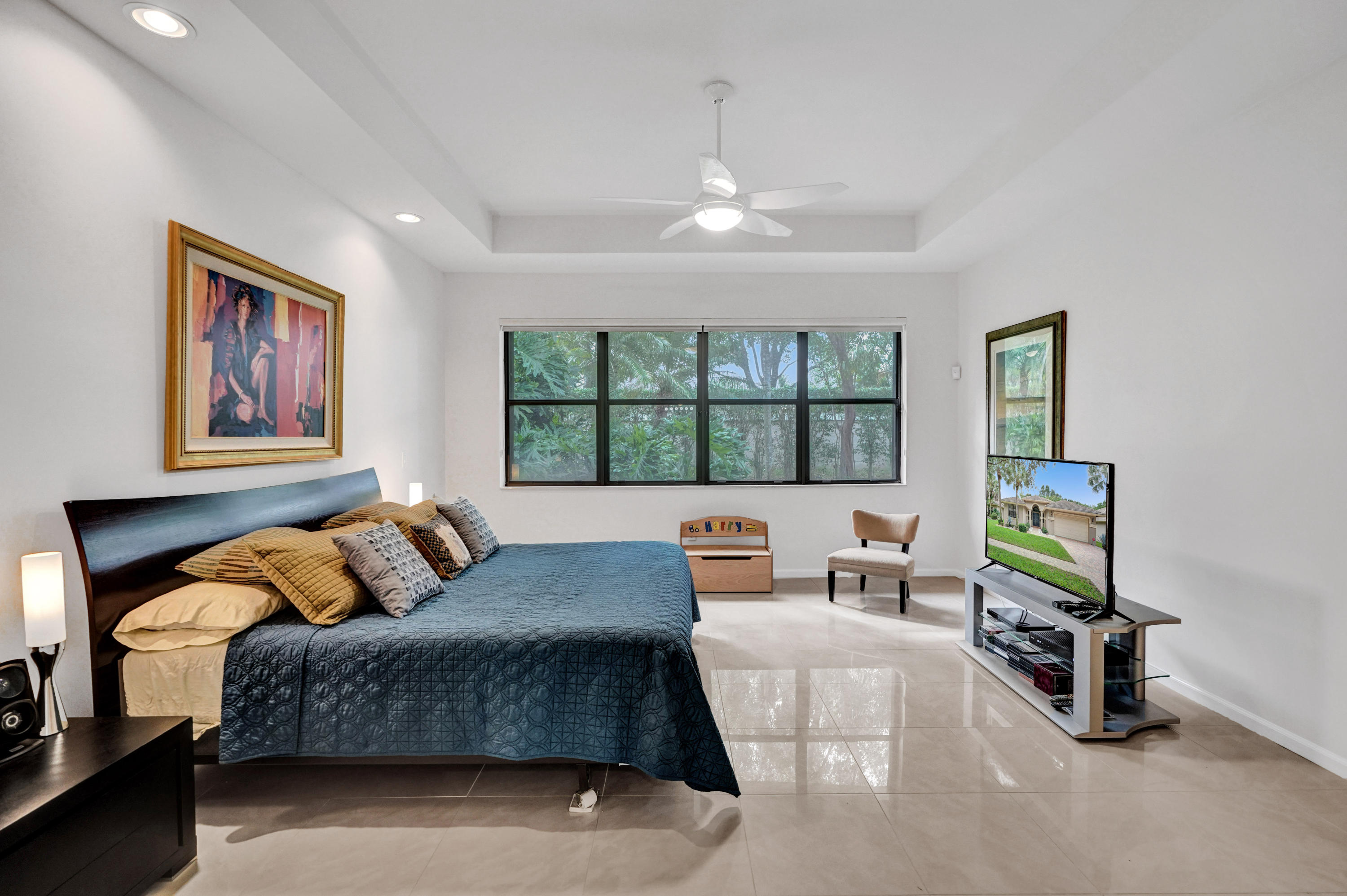 7849 Via Grande Boynton Beach, FL 33437 - Photo 44 of 59 a bedroom with a bed a couch and a window