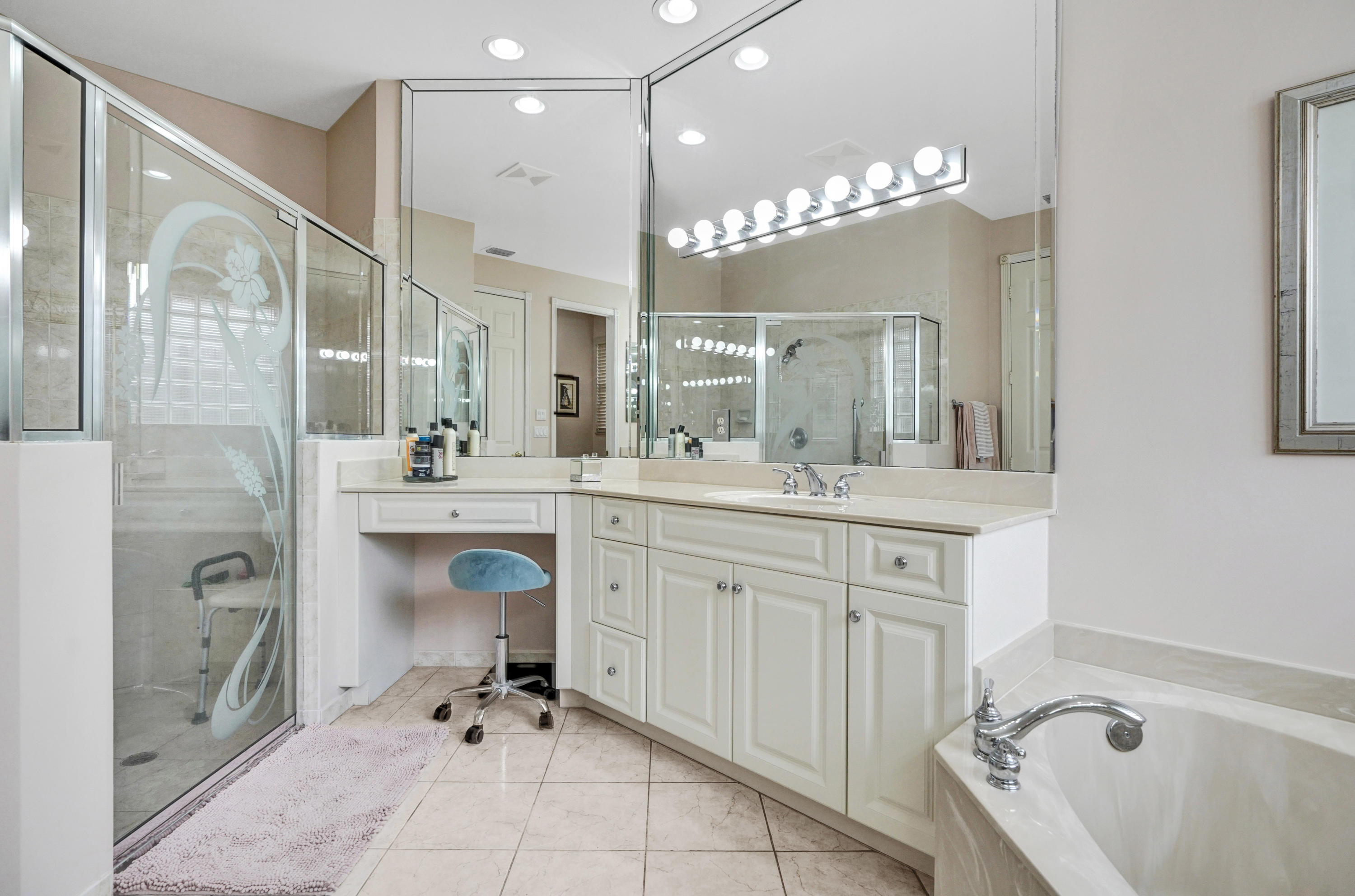 7849 Via Grande Boynton Beach, FL 33437 - Photo 53 of 59 a spacious bathroom with a sink a mirror a bathtub and shower
