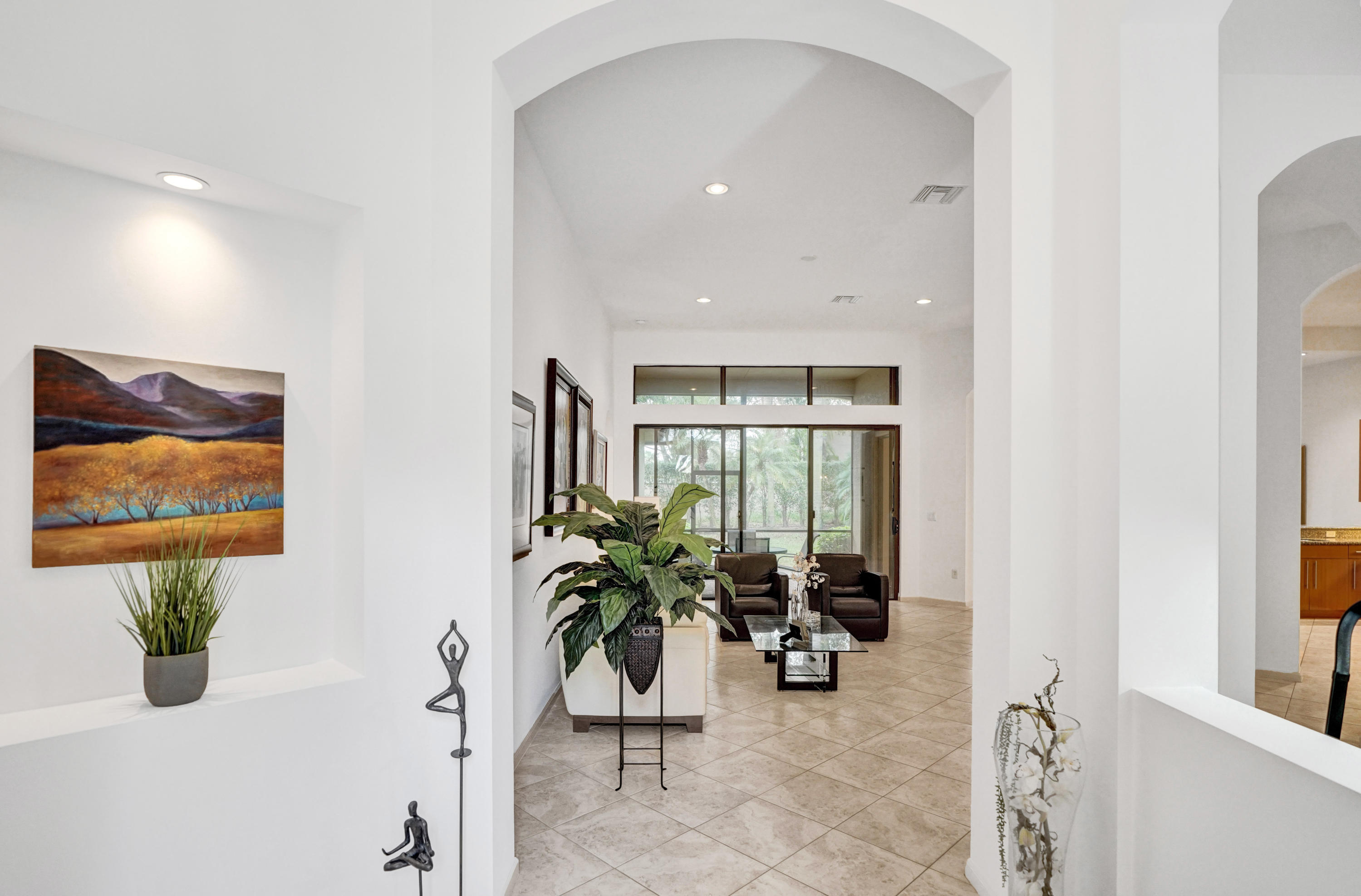 7849 Via Grande Boynton Beach, FL 33437 - Photo 10 of 59 a view of a hallway with wooden floor and a potted plant