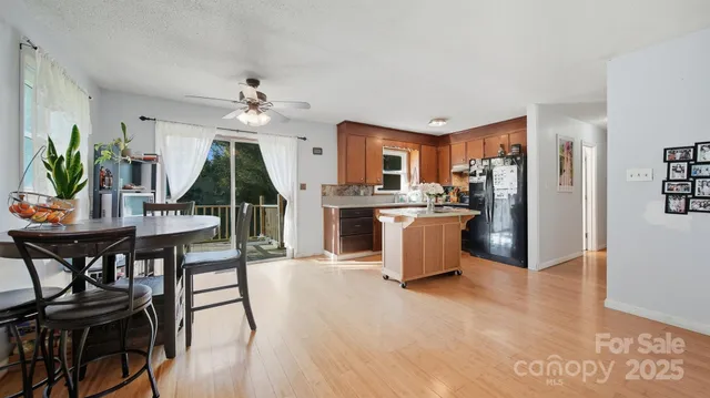 a view of a dining room with furniture and a chandelier
