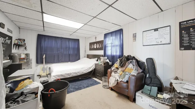 a bed room with furniture and a flat screen tv
