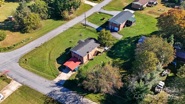 an aerial view of residential house with outdoor space and swimming pool