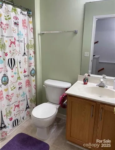 a kitchen with granite countertop a stove a sink a window and dining table