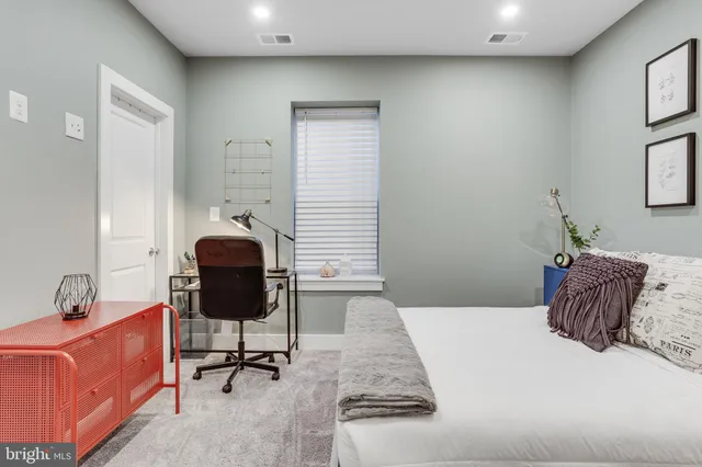 a bedroom with a bed and a chair