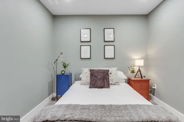 a bedroom with a bed and a lamp