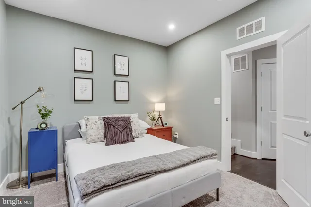 a kitchen with stainless steel appliances granite countertop white cabinets a refrigerator and a stove top oven