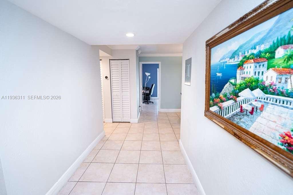 8600 Southwest 109th Avenue, Unit 4114 Miami, FL 33173 - Photo 19 of 44 a view of a hallway with wooden floor and a potted plant