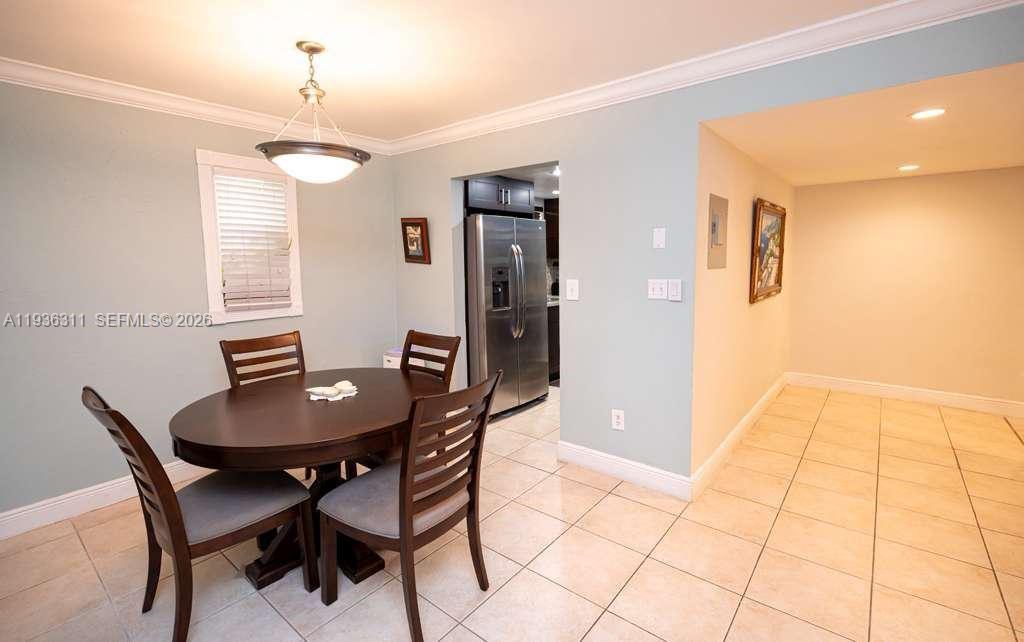 8600 Southwest 109th Avenue, Unit 4114 Miami, FL 33173 - Photo 22 of 44 a view of a dining room with furniture and chandelier