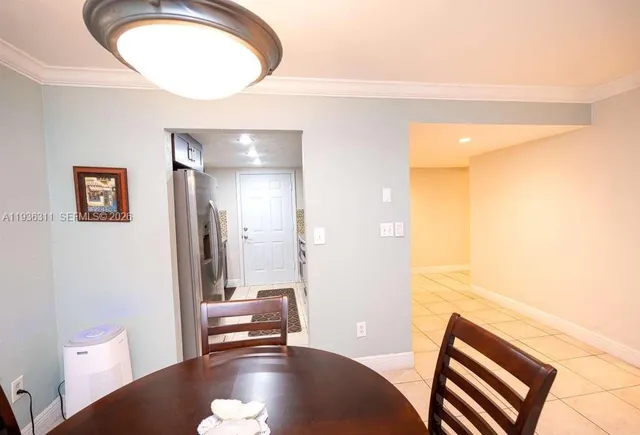 a view of a hallway to a livingroom with furniture