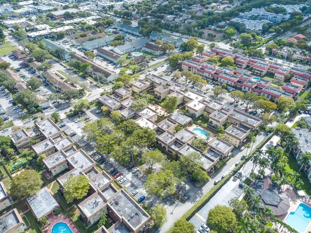 an aerial view of residential houses with outdoor space